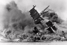 the-battleship-uss-arizona-belches-smoke-as-it-topples-over-into-the-sea.jpg