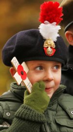 A_boy_wearing_a_Royal_Regiment_of_Fusiliers_cap_poses_for_a_photograph_at_Horse.jpg