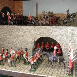 Restored and original Britain's. Scots Guards signal section from Dorset castings under archway.