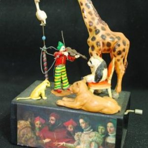 musical box violinist - when the handle is turned. the violinist fiddles while the bird circles overhead. The zoo animals are a silent audience. Johan