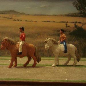 Shetland ponies with boy and girl riders