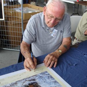 Lynn 'Buck' Compton signing the same print