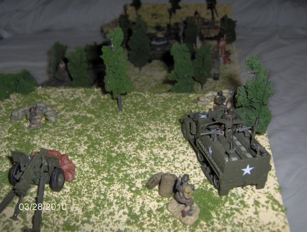 A US half-track, the first mortar, and a 105 Howitzer looking down on the battle below