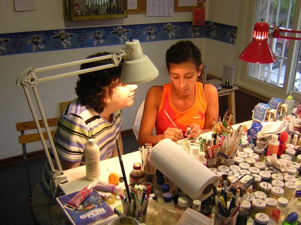 Learning to paint from Lucila, the master painter.