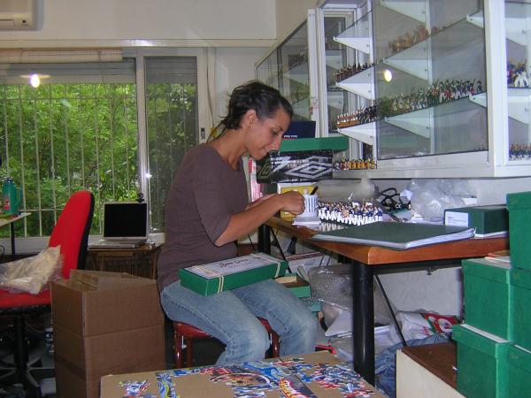 Lucila preparing figures for shipping