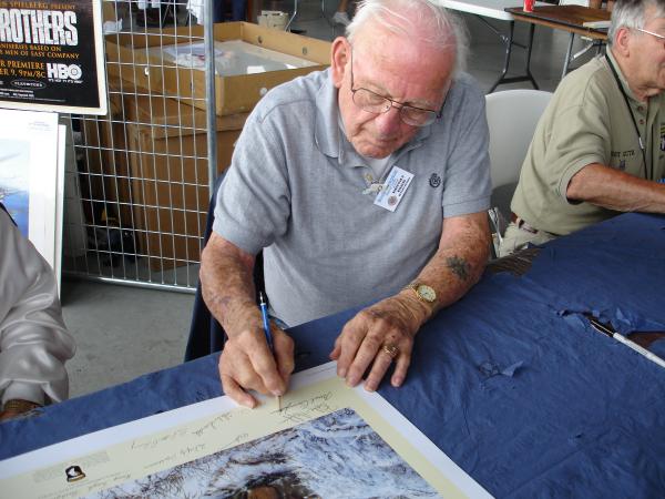 Lynn 'Buck' Compton signing the same print