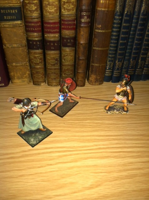 Made in St. Petersburg: Greek,  Persian and Sea People figures having a tussle in bookcase