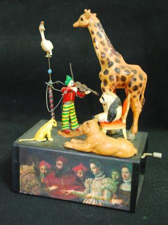 musical box violinist - when the handle is turned. the violinist fiddles while the bird circles overhead. The zoo animals are a silent audience. Johan