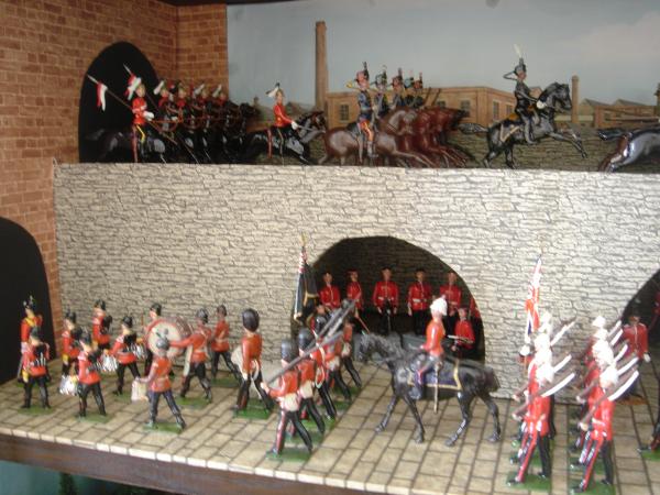 Restored and original Britain's. Scots Guards signal section from Dorset castings under archway.