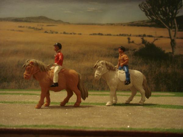 Shetland ponies with boy and girl riders